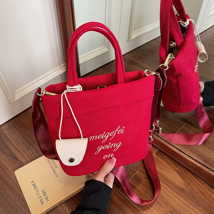 超火小众红色手提包包女式2025夏日新款休闲帆布单肩包通勤斜挎包