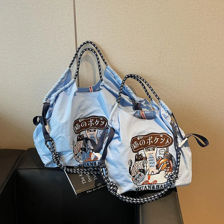 2025新款万针刺绣尼龙包包时尚百搭通勤小众大容量单肩购物袋女潮