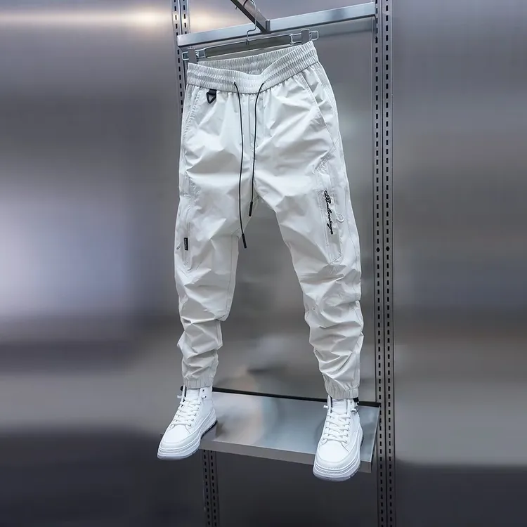 男士春秋薄款透气休闲裤纯色口袋装饰束脚裤弹力松紧腰小脚哈伦裤