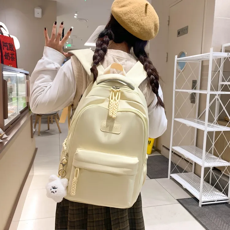 时尚纯色百搭小学生初中生书包女韩版轻便减负背包休闲简约双肩包