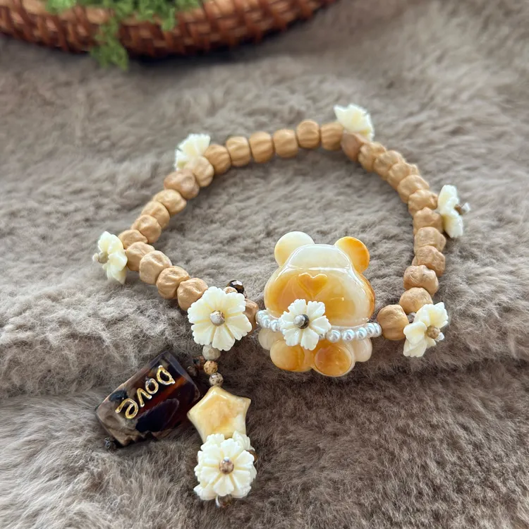 吉月蜜蜡白花小橘熊星星德芙百香籽花花手串