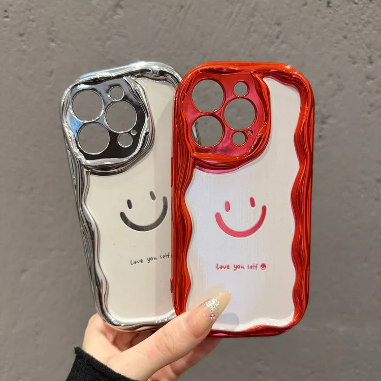 适用苹果16promax华为MATE60小米14电镀曲边创意镂空笑脸手机壳