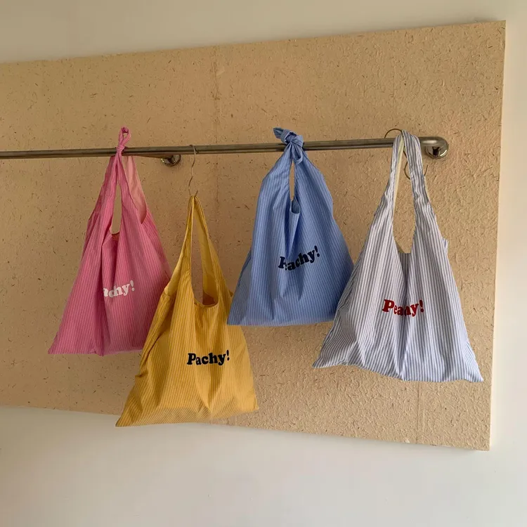 韩系条纹字母印花大容量帆布包2026春夏新款百搭轻便简约单肩包女