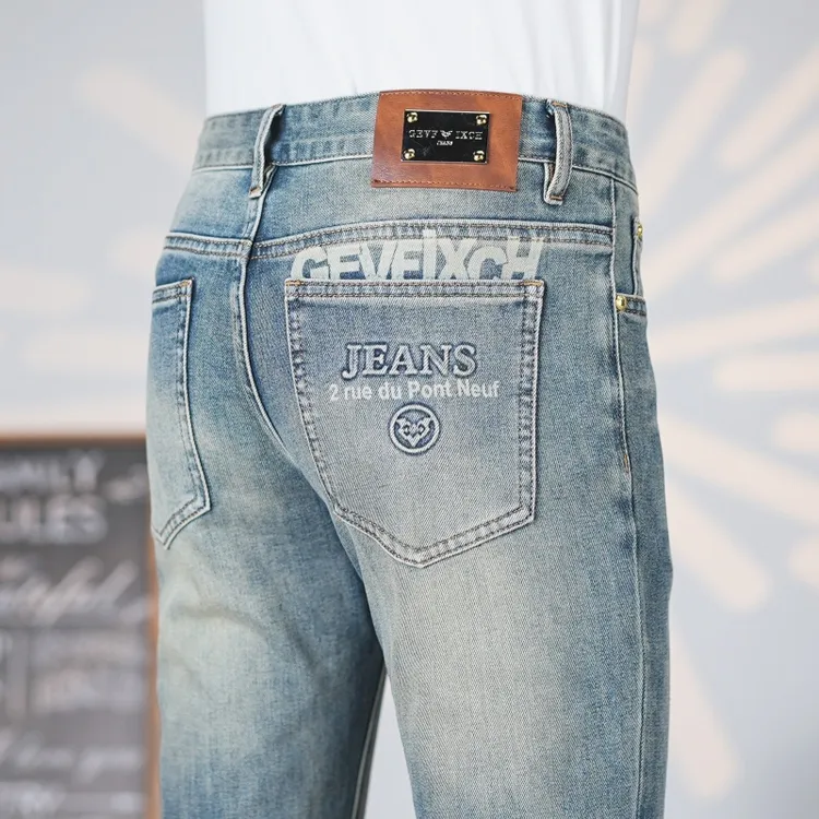 春夏季潮流牛仔裤男士修身弹力水洗怀旧印花浅蓝色时尚百搭帅气