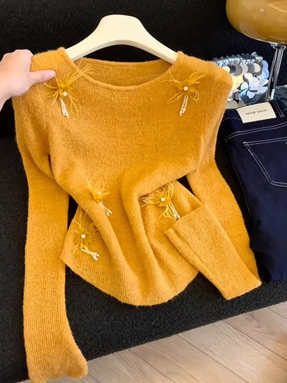 今年新款2025秋季新品南瓜橘色长袖针织女韩版V领设计感显瘦上衣