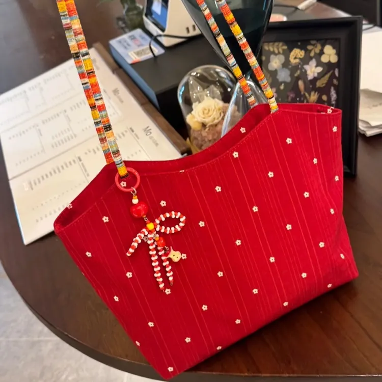 韩系红色花朵帆布包女2025新款撞色编织单肩托特包通勤手提购物袋