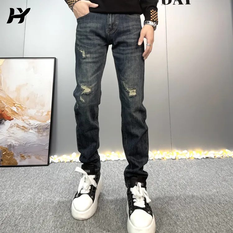 秋季新款高级感复古蓝破洞补丁弹力休闲百搭修身小脚牛仔长裤子男