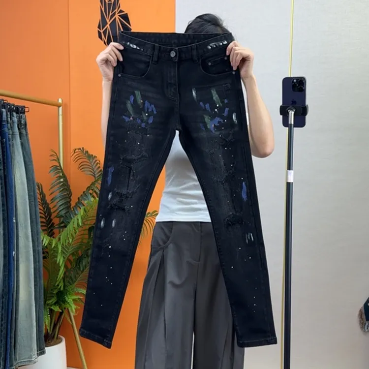 秋季新款修身小脚黑色牛仔裤九分裤时尚个性油漆泼墨假破洞长裤潮