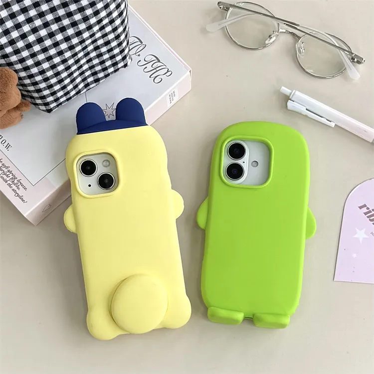 卡通拓麻歌子适用苹果16Pro手机壳iPhone15硅胶支架14防摔保护套