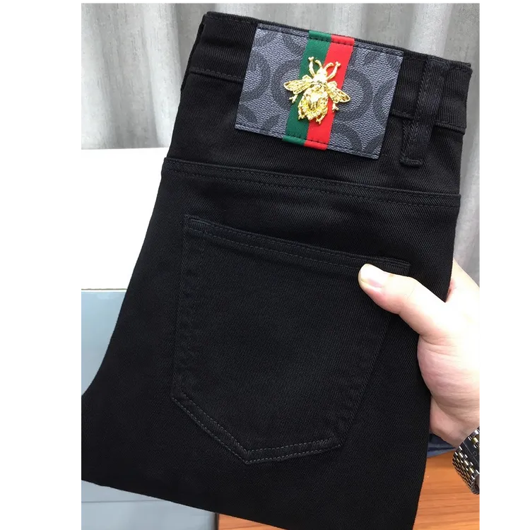 黑色九分牛仔裤男秋冬款欧货轻奢高端修身小脚时尚休闲纯黑长裤男