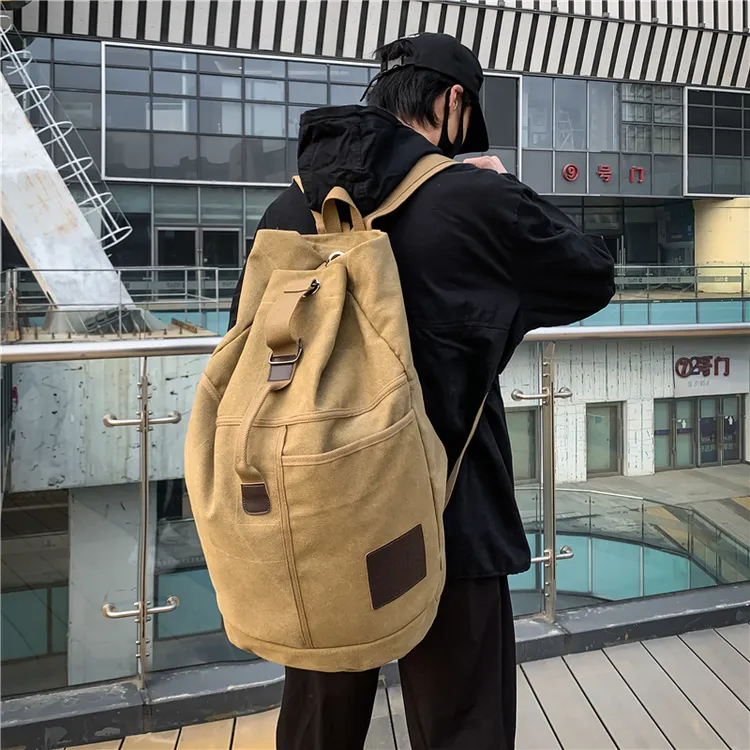 大容量双肩包青年男款学生书包旅行背包帆布圆水桶型帆布包男款