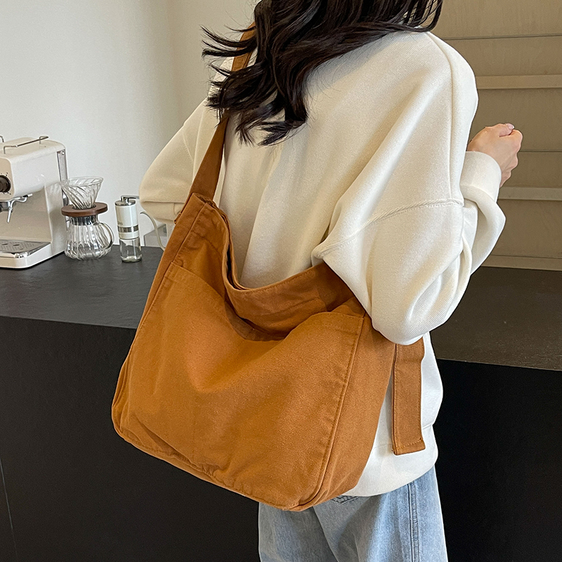 纯色帆布包女休闲大容量斜挎包男女简约时尚学生上课邮差包韩新款