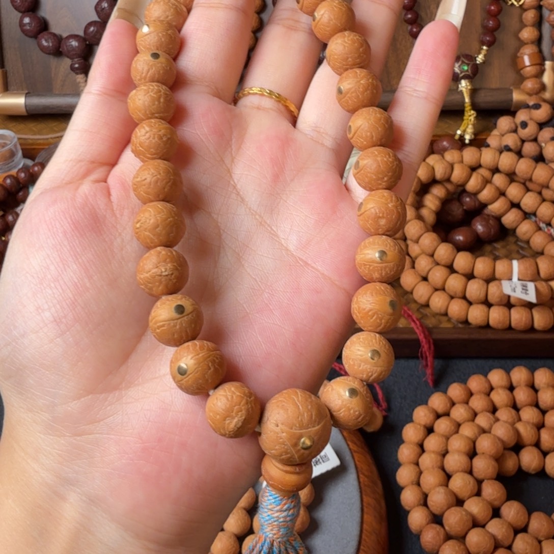 凤眼菩提把件12mm/27颗手持/铜钉