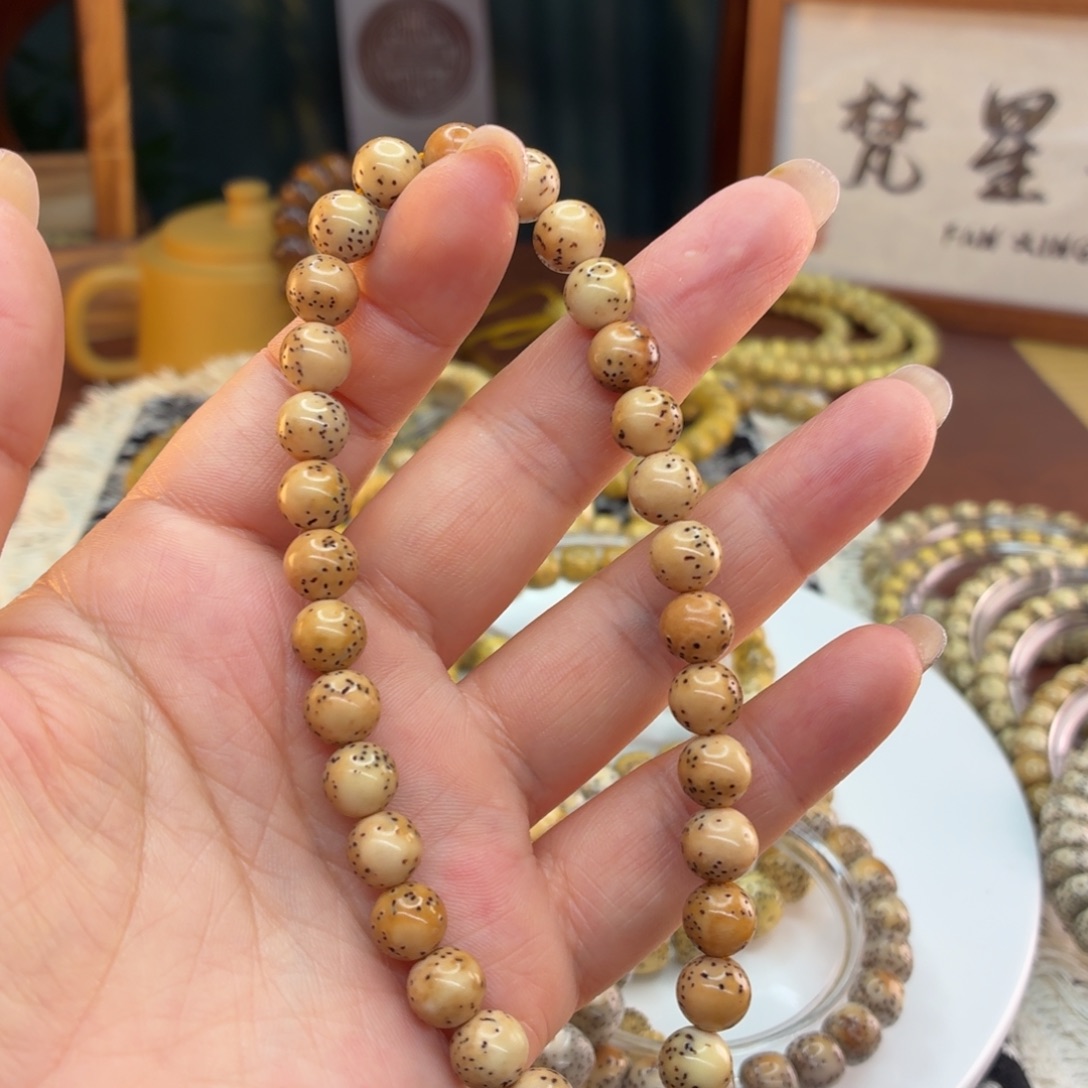 星月菩提吊坠海南星月菩提火烧云河豚手持