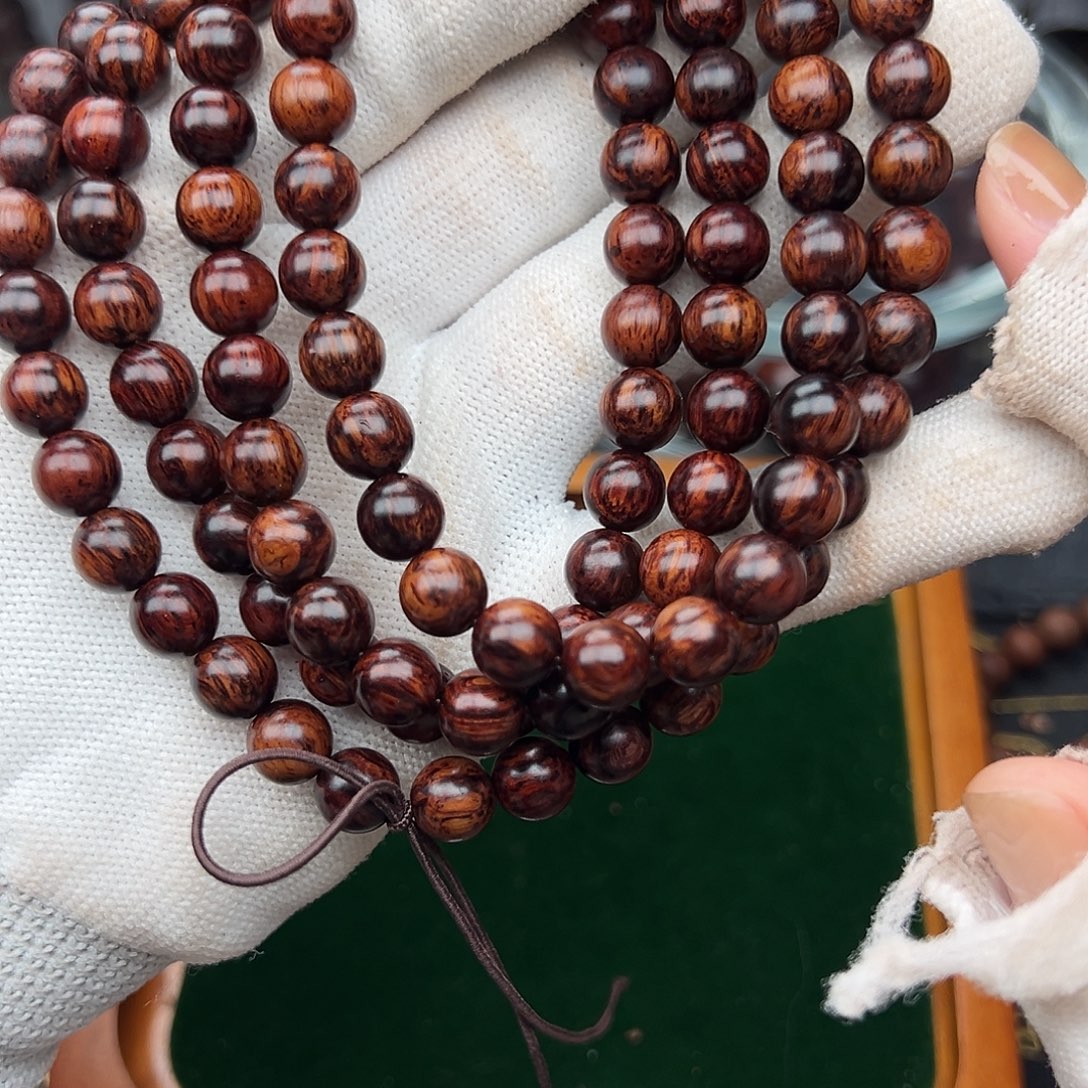 贺***本木0.8海南红降108颗黑金满纹精品