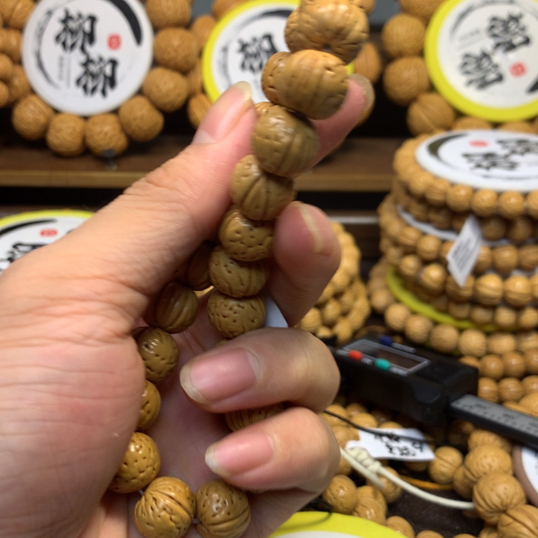 龙***业精品桃核金丹手串