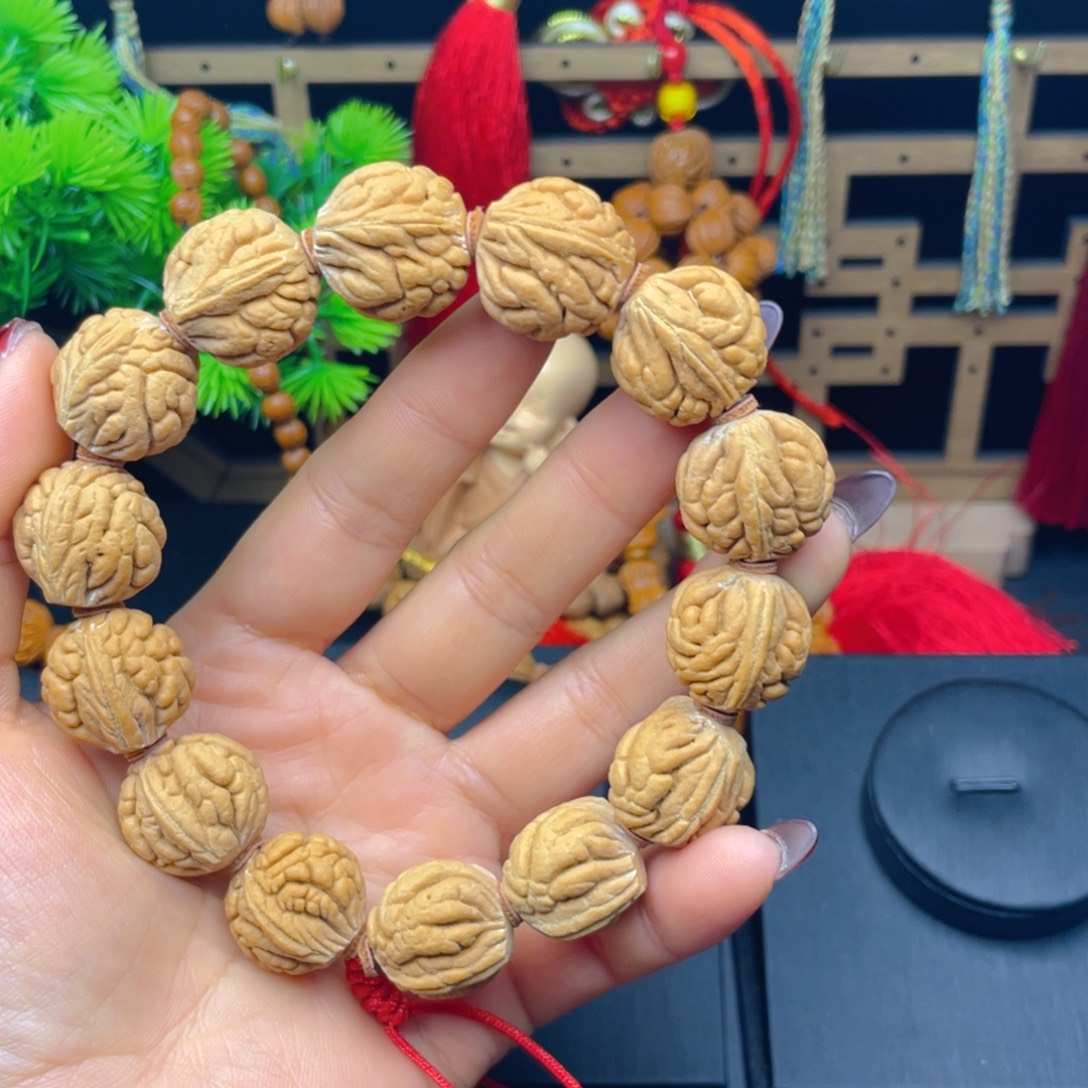风***里手串桃核红红火火。红红火火