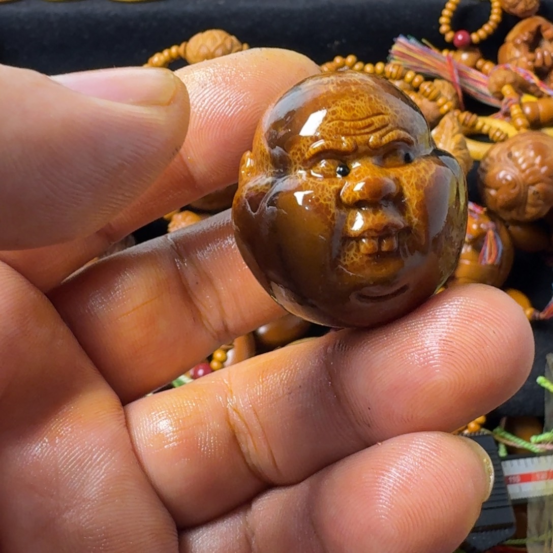 旭***^橄榄核把件富贵头