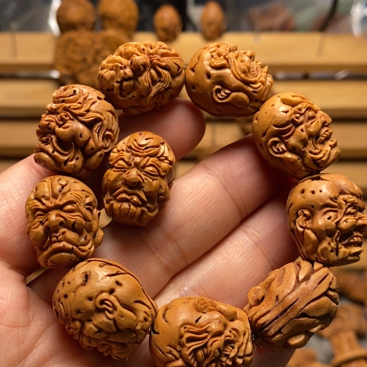 桃核手工雕刻罗汉头手串