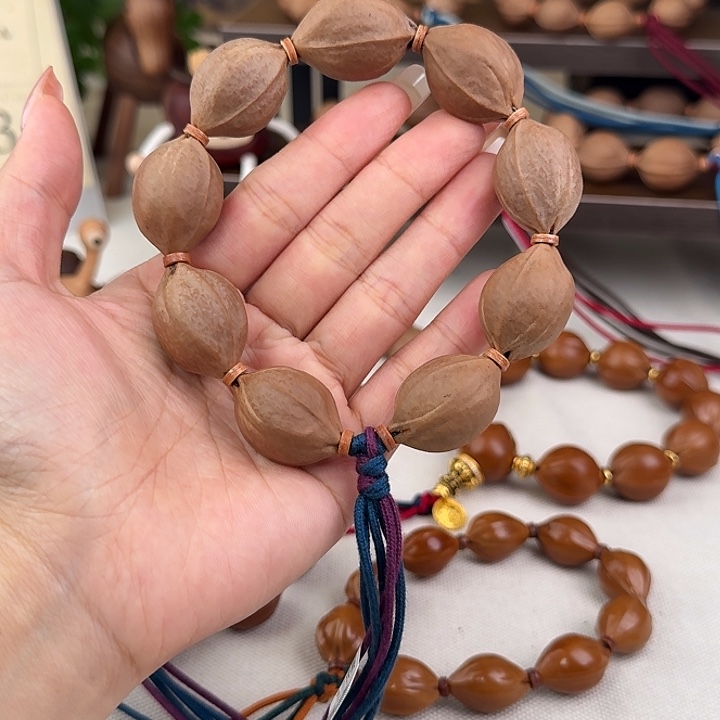 扎***G手串橄榄核20*29三花核串