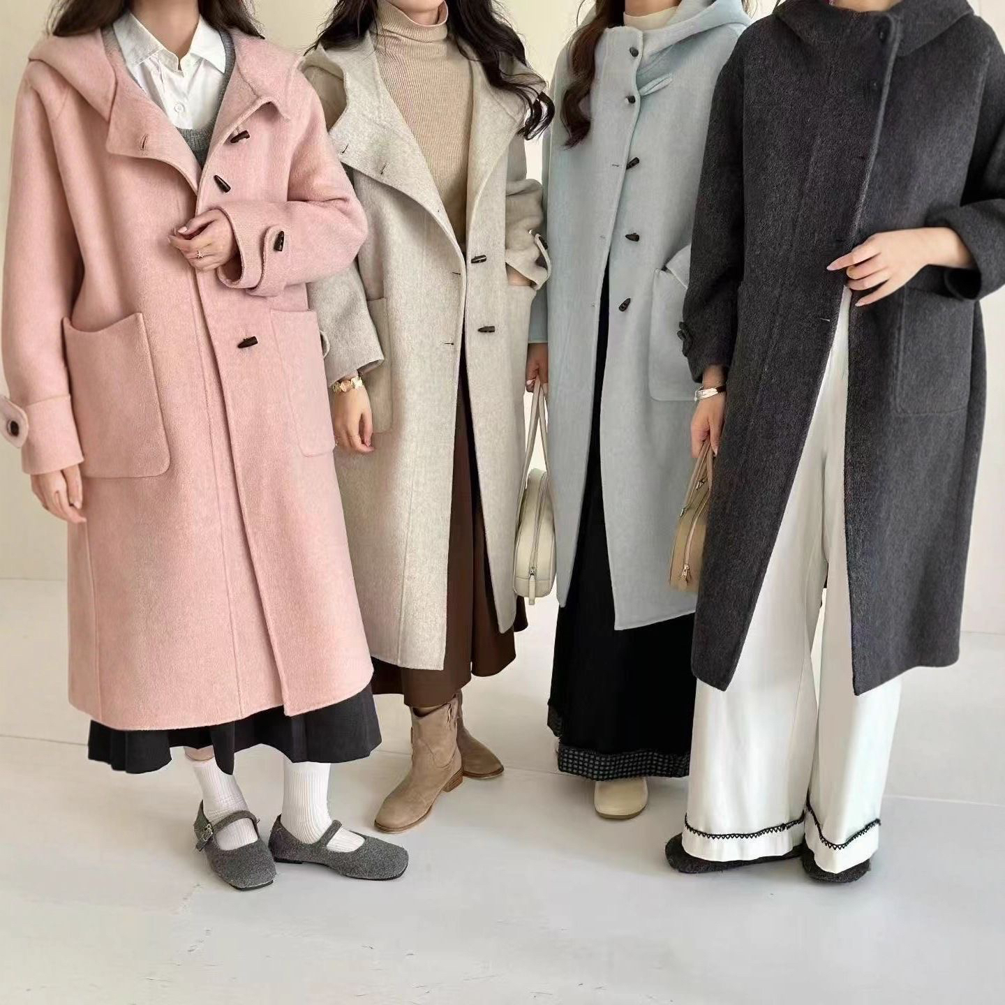 高级感休闲连帽牛角扣双面羊毛大衣女中长款气质毛呢外套秋冬新款