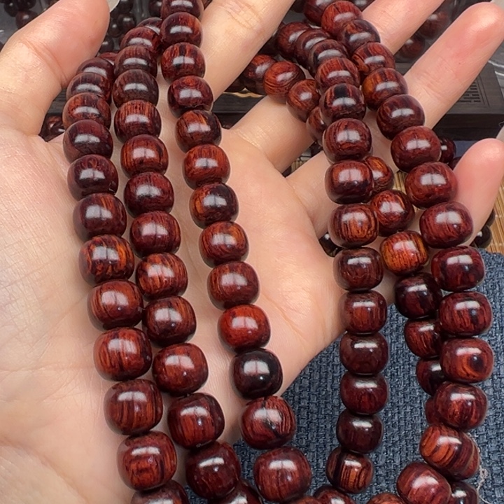 丽***志木海南红降顺纹黑金线0910老型108颗（瑕）