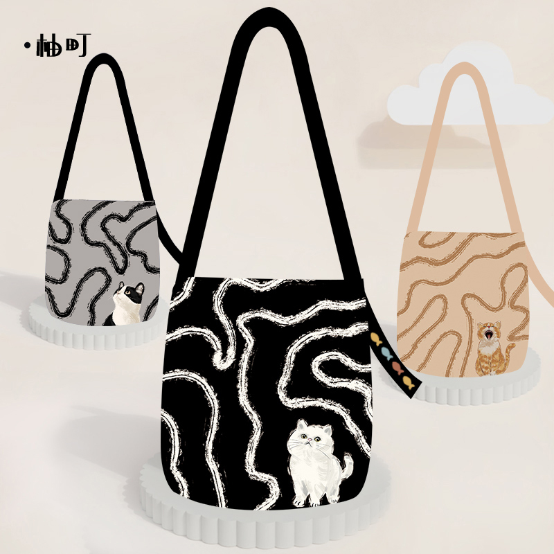 柚町x原创插画抽象小白喵百搭大容量通勤水桶包简约小众时尚斜跨