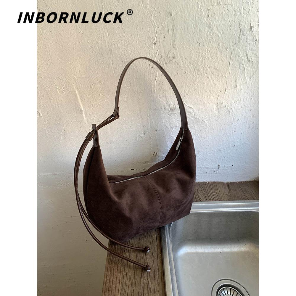 今年流行麂皮绒包女2025新款时尚覆古单肩饺子包大容量通勤斜挎包