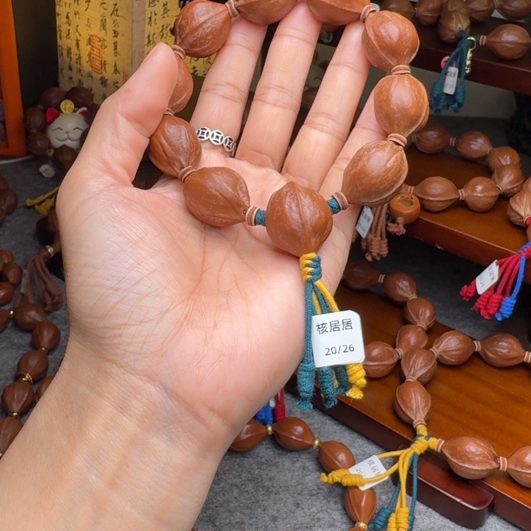 彭****橄榄核手串20/26带三通 老核原皮 梅林铁核