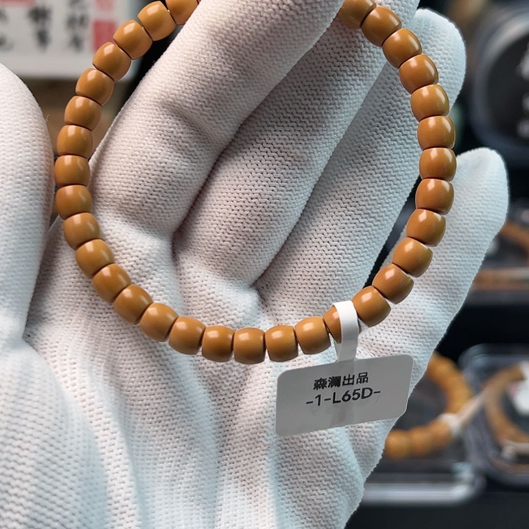 橄榄核手串老挝核尖直切单圈65缩64微白