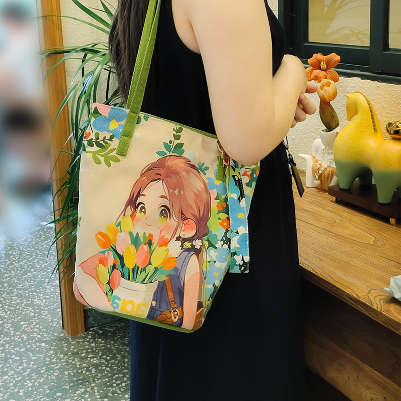 花女孩单肩斜挎水桶包新款印花可爱插画文艺时尚通勤百搭手提布包