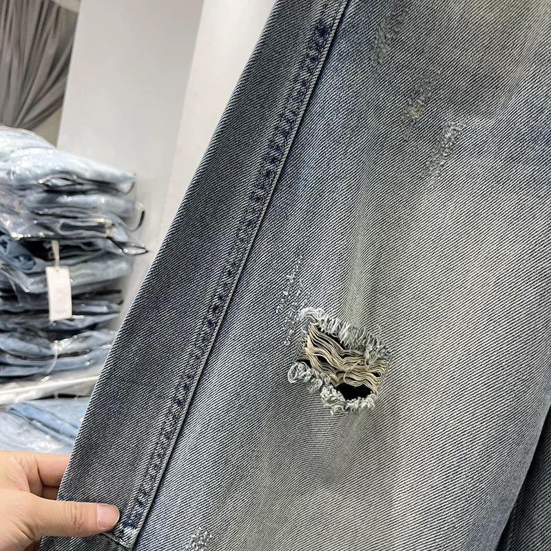 浅蓝色破洞牛仔裤弯刀设计阔腿裤配腰带休闲长裤