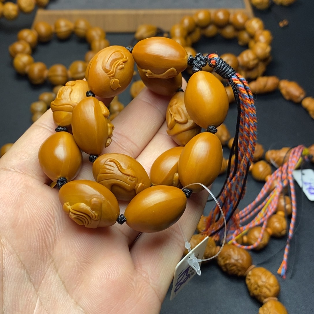 黄***王橄榄核手串/手链无相佛手持