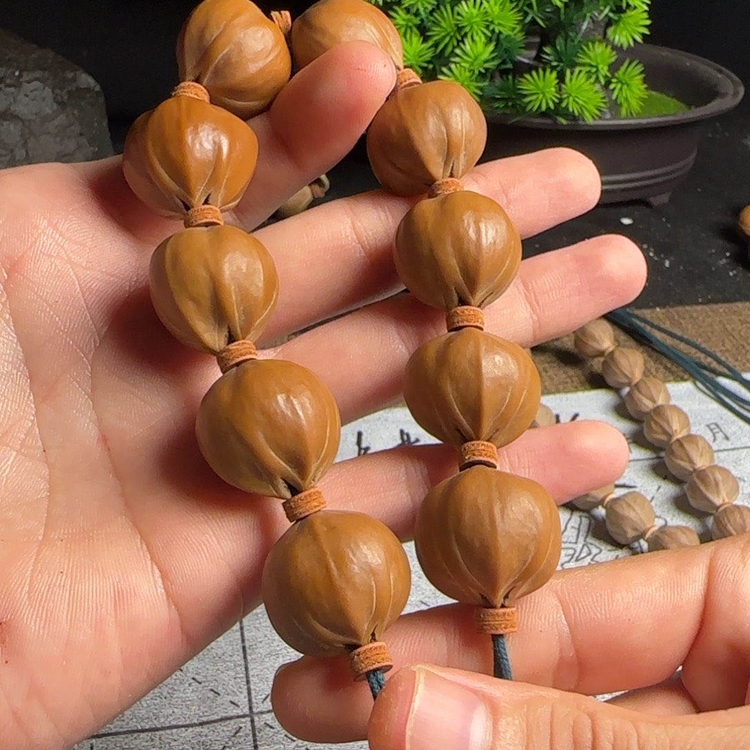 岳***生橄榄核2.2四花手串11颗铁核
