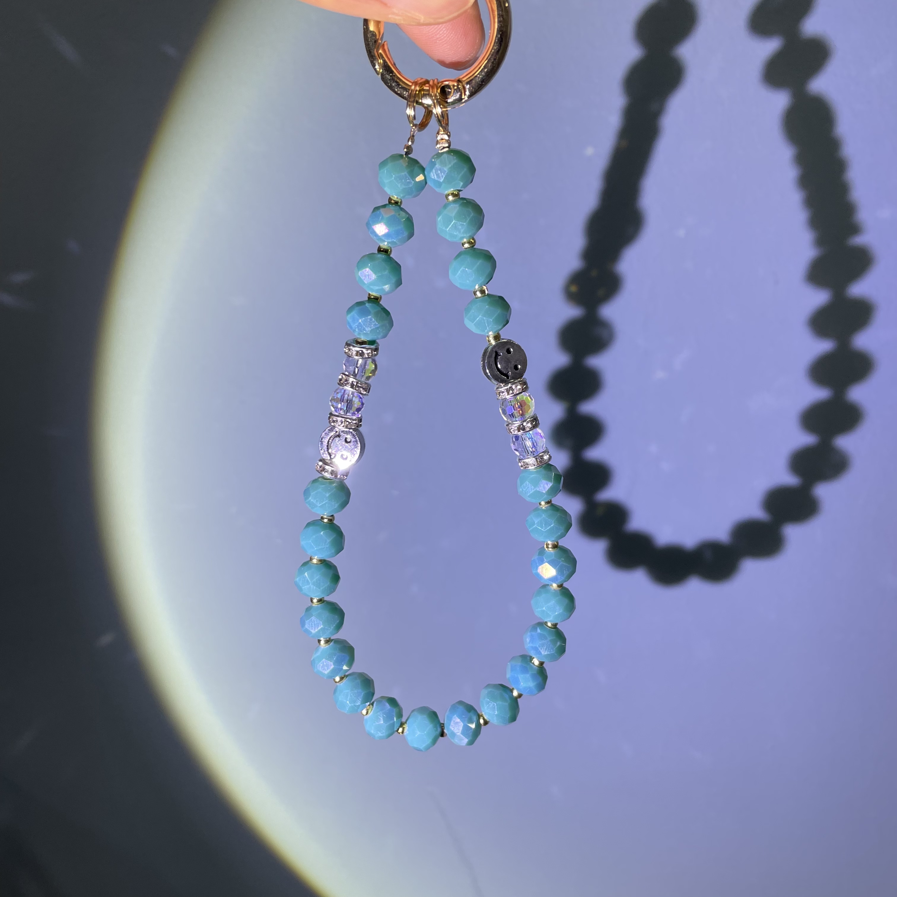 编织孔雀蓝笑脸手机链C01